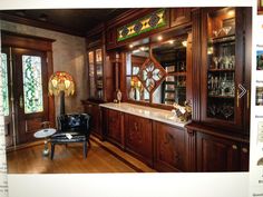 the interior of the bar features wine refrigerator, sink, and large collection of glassware