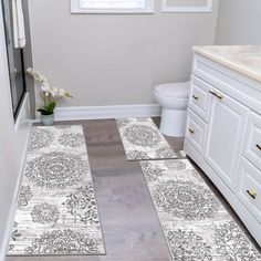 the bathroom is clean and ready to be used as a place for toilet paper or rugs