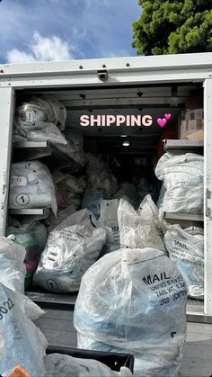 the back of a moving truck filled with bags and supplies for shipping to people in need