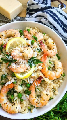 a white bowl filled with rice and shrimp next to a slice of lemon wedged cheese