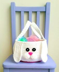 a crocheted bunny bag sitting on top of a blue chair next to a wall