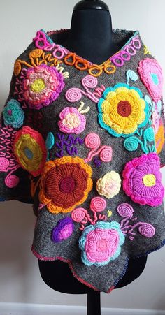 a woman's gray sweater with colorful crochet flowers on the front and sides