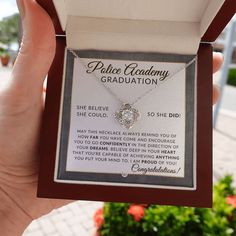 a person holding up a gift box with a necklace in it that says to the beautiful woman on my wedding day