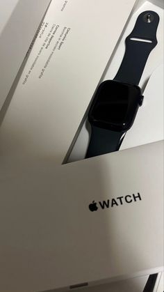 an apple watch box is open and sitting next to it's packaging