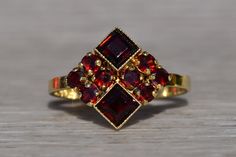 The Amwell: Ladies Signed 14K Mid Century Cocktail Ring set with Garnet. Crafted in 14 karat yellow gold is this vintage mid century styled ring set throughout with garnets. From North to South, you will see two square emerald cut garnets bezel set and decorated with fine milgrain. To the left and right are four round cut diamonds on either side. Currently the ring is a finger size 6.5 and is able to be resized for an additional fee upon request. Love this piece, but don't have the money to spen Ruby Engagement Ring, Yellow Gold Chain, Beaded Hoops, Garnet Rings, Pendant Rings, Jewelry Inspo, Dream Jewelry, Vintage Ring, Fine Jewellery