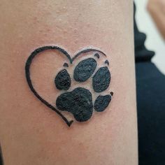 a dog paw print in the shape of a heart on a woman's thigh