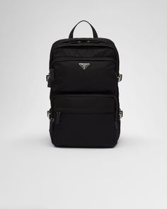 Black Re-Nylon and Saffiano leather backpack | PRADA Luxury Leather Bag With Logo Patch, Luxury Leather Bags With Logo Patch, Luxury Nylon Bags With Logo Patch, Luxury Nylon Backpack With Zipper Closure, Luxury Nylon Standard Backpack, Designer Nylon Backpack For Travel, Modern Travel Backpack With Logo Patch, Designer Black Nylon Backpack, Luxury Nylon Backpack