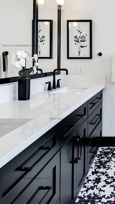 a black and white bathroom with double sinks