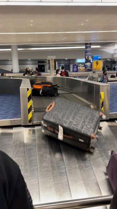 an airport baggage claim area with luggage on the conveyor belt