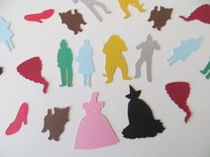 the silhouettes of people in different colors are arranged on a white surface with shadows