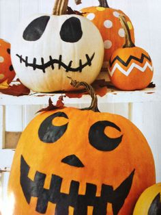 three pumpkins with faces painted on them