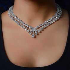 a woman wearing a diamond necklace on her neck