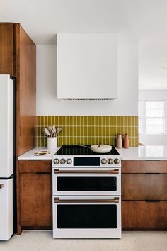 a white stove top oven sitting inside of a kitchen