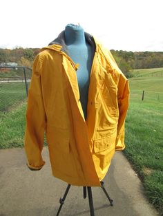 "nice, lined coat with pockets, snaps ,2 high  side pockets and 2 lower pockets misty habor size med bust 24 x2 31\" long  draw sting around waist and on hood" Yellow Double-lined Hooded Outerwear For Fall, Yellow Hooded Parka With Pockets, Casual Yellow Weatherproof Raincoat, Yellow Hooded Raincoat For Winter, Yellow Long Sleeve Outerwear For Rainy Season, Yellow Waterproof Windbreaker For Fall, Yellow Hooded Rainy Season Outerwear, Yellow Raincoat For Fall Outdoor Use, Yellow Windbreaker For Rainy Spring Weather