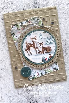 a close up of a card with a deer and dog design on the front side