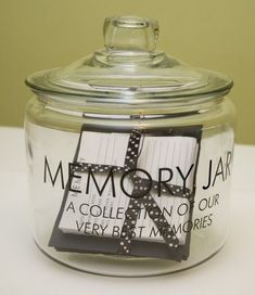 a glass jar with a ribbon on the lid that says memory jar, a collection of our very best memories