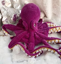 an octopus stuffed animal sitting in the snow