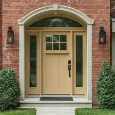 the front door to a brick house with an arched window