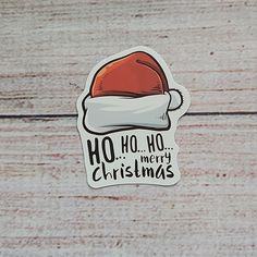 a sticker with the words ho ho merry christmas on it and a santa hat