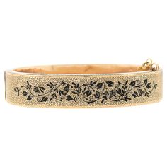 This unique and absolutely gorgeous antique bangle bracelet was crafted in solid 14k gold during the Victorian period and features a wide design covered with incredible textured work throughout, and adorned with two sides of very fine and neat black enamel patterns for such an attractive and elegant touch. This bracelet measures 13.2mm wide and wears comfortably with a nice bold look on the wrist, securing with a sturdy push clasp and has a 3 inch safety chain for guaranteed wear. The original patina has been preserved on this bangle which gives the gold its rosy yellow appearance and makes it even more desirable to wear and own by antique lovers. An absolutely gorgeous piece in amazing condition and ready to wear. Enjoy :) Material: Solid 14K Rosy Yellow Gold Weight: 23.62 Grams Type: Ban Luxury Bohemian Engraved Bangle, Luxury Victorian Gold Cuff Bracelet, Luxury Antique Etched Bangle, Victorian Period, Safety Chain, Black Enamel, Bangle Bracelet, Bangle Bracelets, Patina