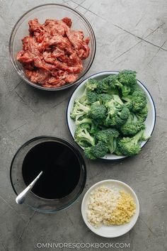 broccoli, meat and rice are on the table next to bowls with sauce