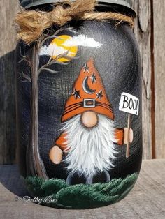 a painted jar with a gnome holding a sign