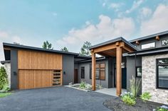 a modern house with two garages and an attached carport in the front yard