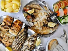 a table topped with lots of different types of food and silverware on top of it