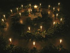 many candles are lit in the shape of a circle