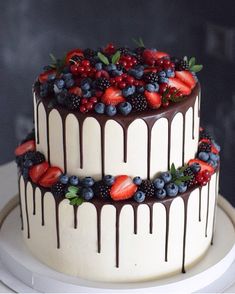 a cake with chocolate icing and berries on top