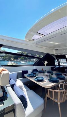 the interior of a boat with tables and chairs