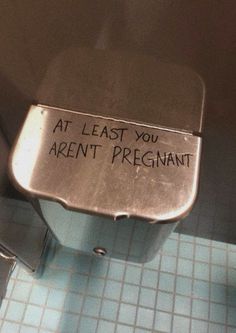 a sign that says at least you aren't pregnant on the side of a toilet