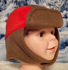 Brown and Red Accent Children's Winter Hat This hat is right on trend with today's fashion for children. It's fun, fashionable, warm and cozy and perfect to wear on a cold winter's day. The hat is made with anti pill fleece. Straps close with velcro.  -Perfect cold weather fashion accessory to keep you warm cozy and stylish -This hat will be a perfect cold weather accessory for any cold outdoor. -For all occasions and three seasons - winter spring and fall. This hat is soft and comfortable for a Playful Brown Winter Hat, Fun Adjustable Hats For Cold Weather, Red Fun Outdoor Hat, Fun Red Outdoor Hat, Red Beanie For Cold Weather, Playful Warm Hats For Outdoor, Red Bonnet For Winter, One Size Fits Most, Adjustable Red Hat For Cold Weather, Red Winter Bonnet, One Size Fits Most