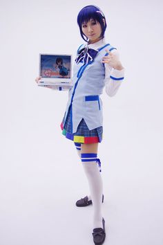 a woman dressed in school uniform holding a laptop