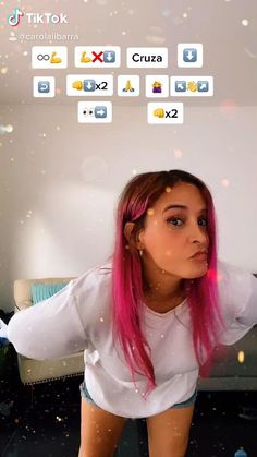 a girl with pink hair is looking at the camera