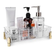 a clear bathroom caddy filled with personal care items