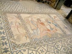 an old mosaic with some people on it