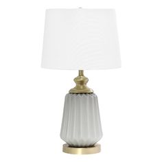 a white lamp with a gold base and a white shade on the top of it