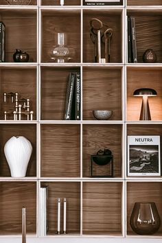 the shelves are filled with books and vases