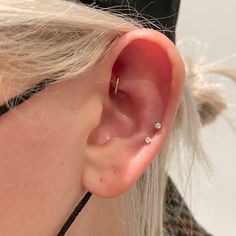 a close up of a person's ear with a nose piercing