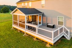 an aerial view of a two story house with deck and patio in the foreground