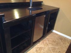 a kitchen with a sink, dishwasher and cabinets in the middle of it