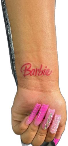 a woman's foot with the word barbie written on it and pink nail polish