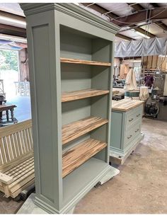 the shelves are made out of wood and painted green