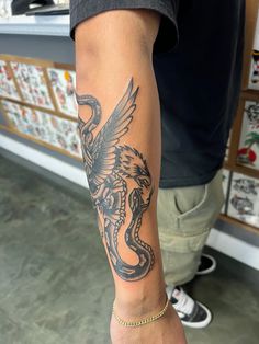 a man with a dragon tattoo on his arm