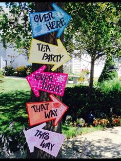 a tree with signs on it that say tea party, over there and that way