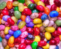 a bowl filled with lots of different colored candies on top of eachother