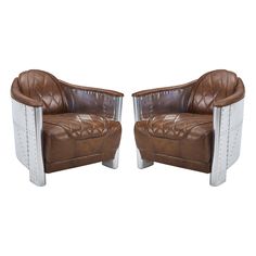 a pair of brown leather chairs sitting next to each other on top of a white floor