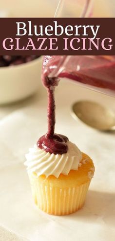 blueberry glaze icing being poured onto a cupcake