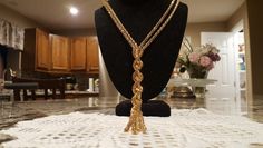 This is a stunning vintage knot/tassel necklace. This piece will compliment any dress or blouse. This necklace measures 19 inches long. It falls just perfectly and looks great. It has that classic look that is always in style. Elegant Tassel Necklace For Party, Elegant Long Tassel Necklace, Elegant Long Tassel Necklace With Fringe, Elegant Long Gold Tassel Necklace, Elegant Gold Long Tassel Necklace, Elegant Long Fringe Necklace, Gold Tassel Necklace For Party, Elegant Gold Necklace With Tassels, Elegant Lariat Tassel Necklace With Adjustable Chain